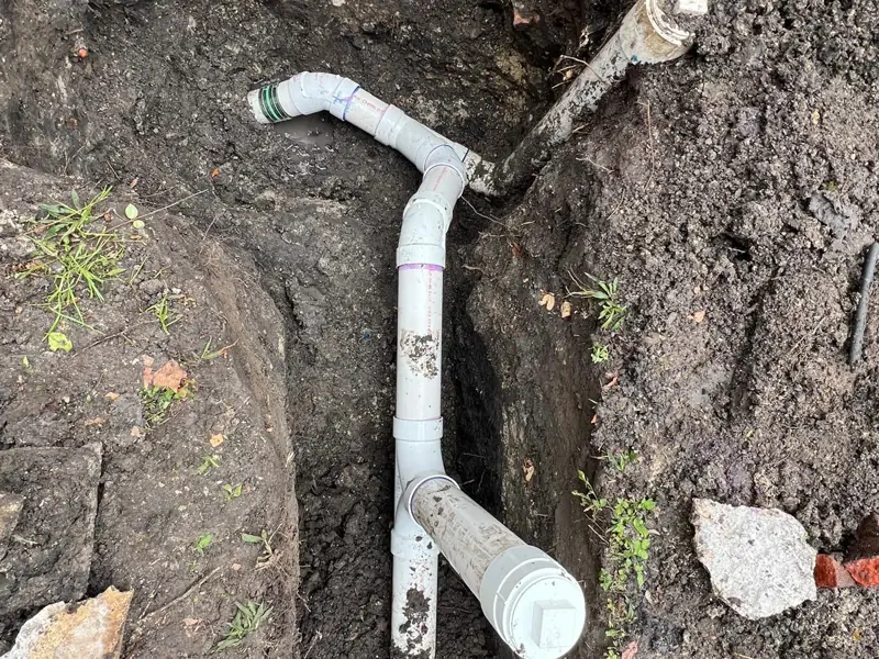 A wye and a riser where the line leaves the house